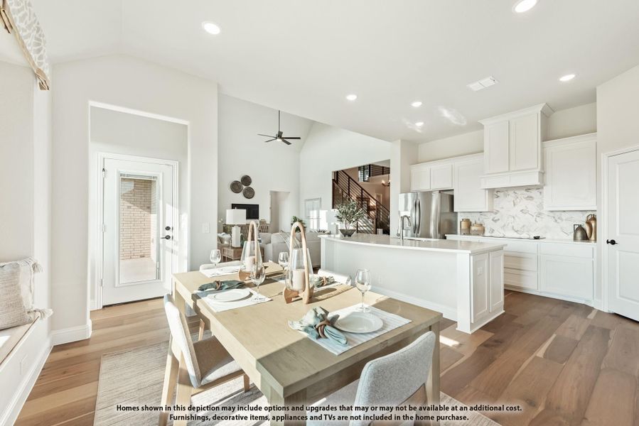 Open-concept dining area and kitchen with white cabinets, wood floors, and large island with stainless steel appliances Open-concept dining area and kitchen with white cabinets, wood floors, and large island with stainless steel appliances