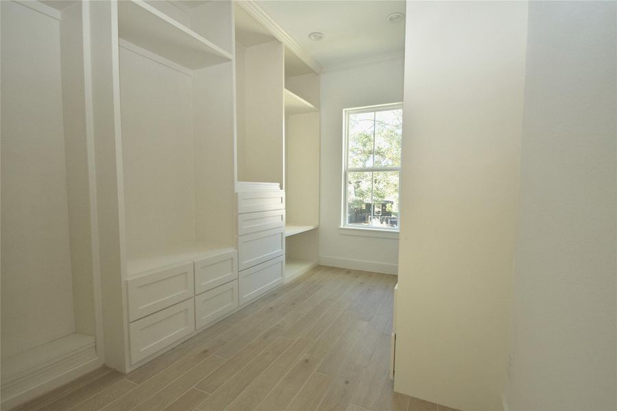 Primary closet with custom shelving & drawers