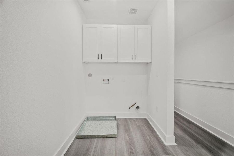 The laundry room is upstairs and has both gas and electric hookups for the dryer, plus a washer hookup with a pan for extra protection.