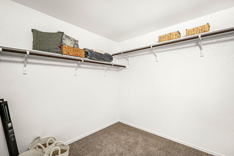 This is the primary closet in the Hawkins plan within the model home in Carillon at 13305 Eppright Trace Blvd., Manor, TX. This is the primary closet in the Hawkins plan within the model home in Carillon at 13305 Eppright Trace Blvd., Manor, TX.