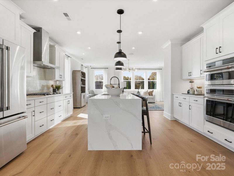 Large Central Island Ideal for Casual Dining and Entertaining. *Model Photos | Actual Finishes, Structural Selections, and Orientation May Vary. Large Central Island Ideal for Casual Dining and Entertaining. *Model Photos | Actual Finishes, Structural Selections, and Orientation May Vary.