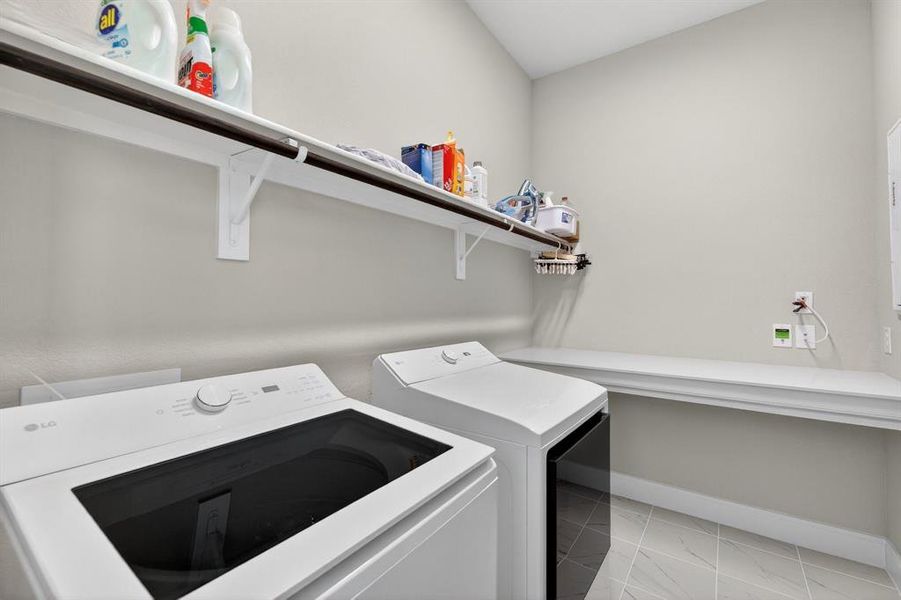 Spacious laundry with table for folding & storage underneath