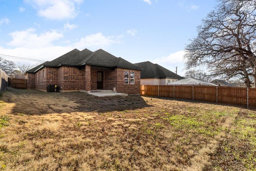 Back of house with a patio, central AC, and a lawn