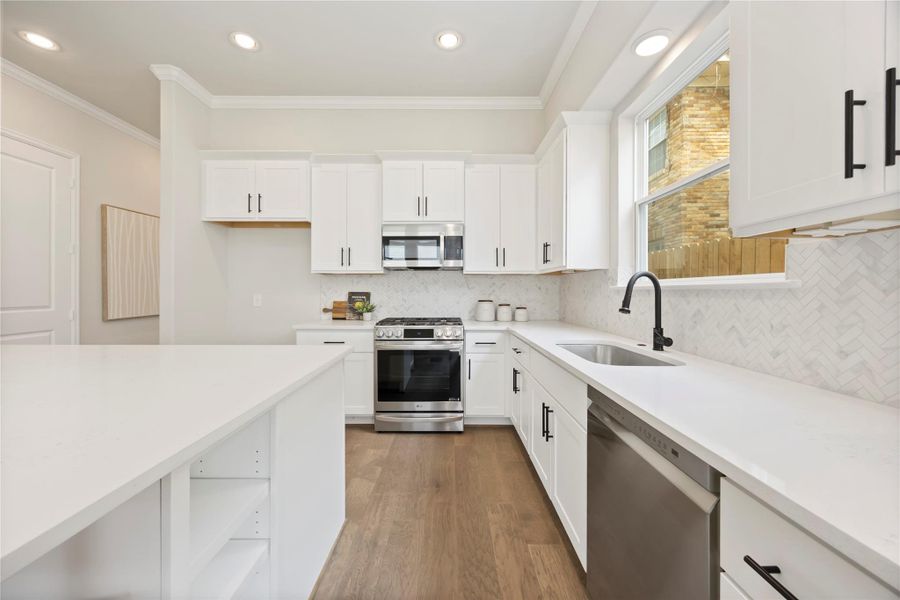 The kitchen's open design seamlessly transitions into the spacious living room, affirming the beauty of an interconnected living space.