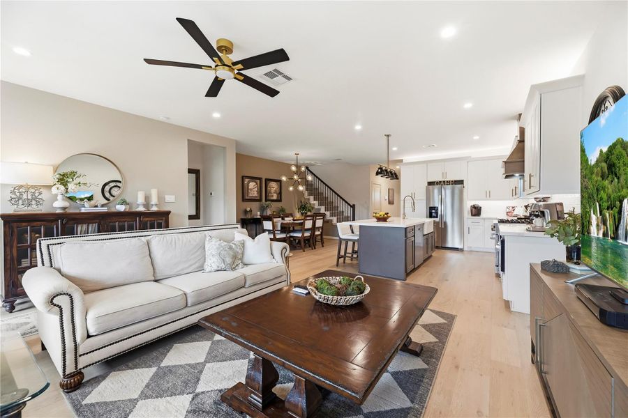 Living room looking toward the kitchen, showing the open floor plan and hardwood flooring of this 2,313 sq ft home.