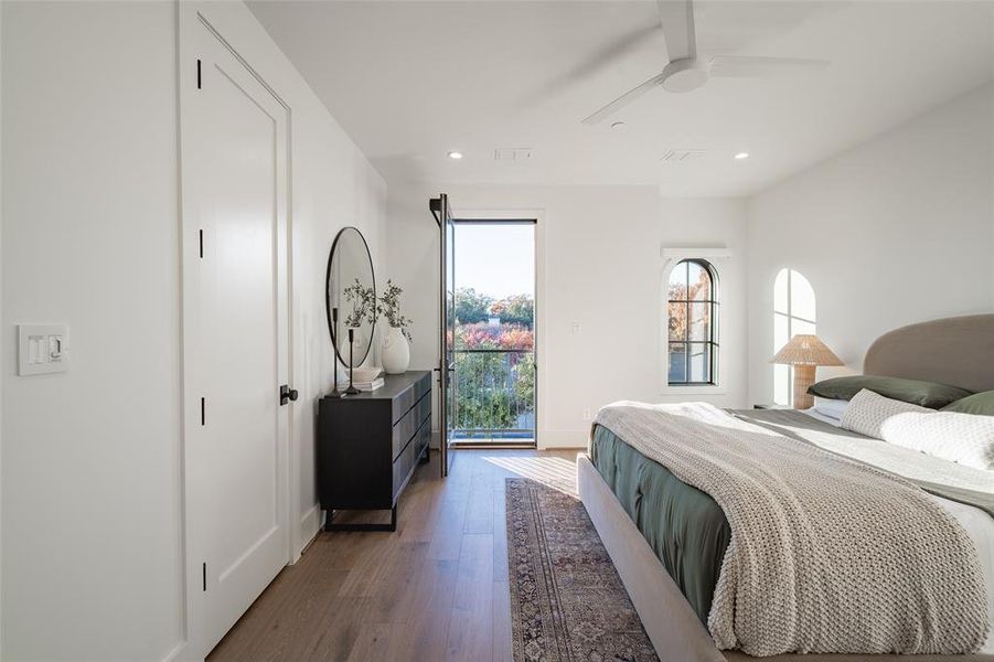 Bedroom with hardwood / wood-style flooring and ceiling fan