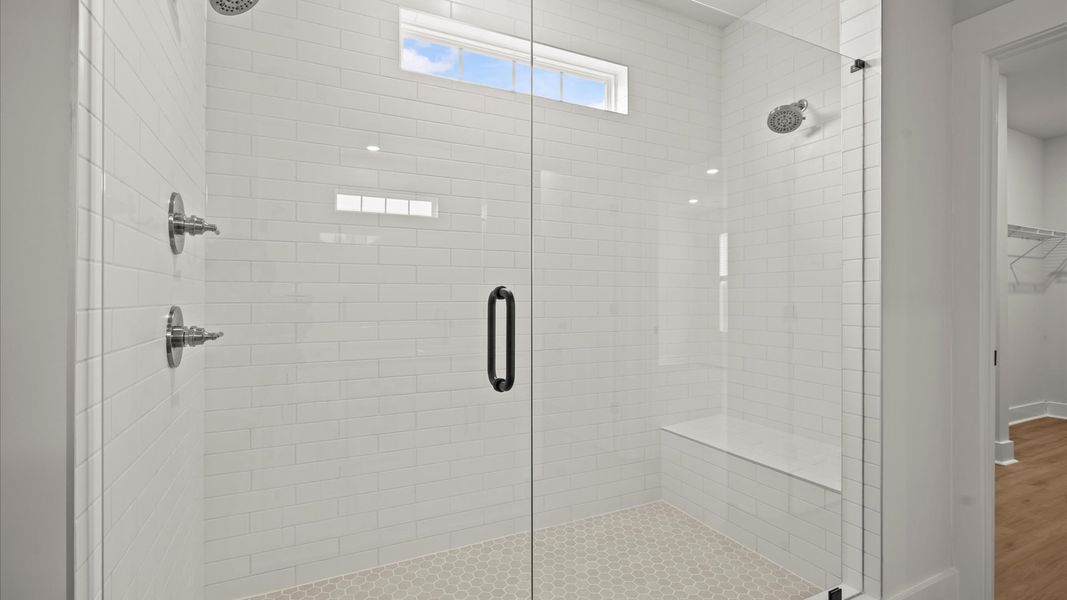 Notable primary suite with dual vanities and tiled walk-in shower in this prime home Notable primary suite with dual vanities and tiled walk-in shower in this prime home