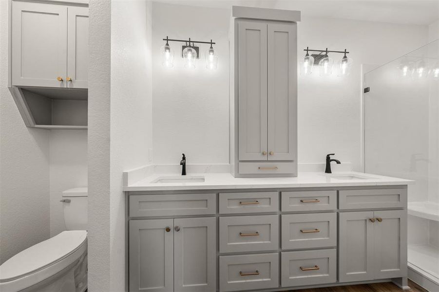 Bathroom featuring double vanity and toilet Bathroom featuring double vanity and toilet