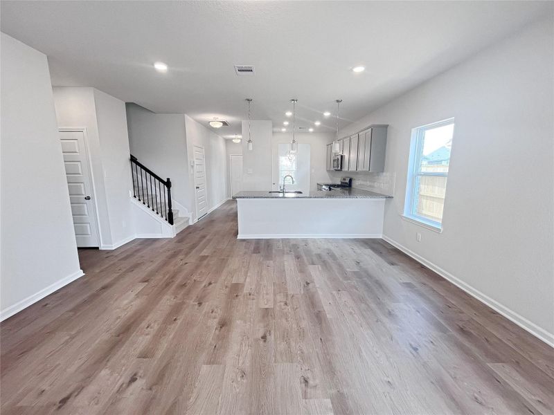 The Caldwell- Family Room into Kitchen. Sample image for illustration; upgrades, options, and colors may vary.