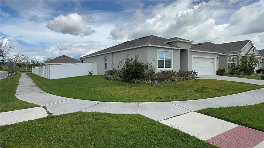 Front exterior of a new home in , Kissimmee, FL, highlighting curb appeal (Image 19).
