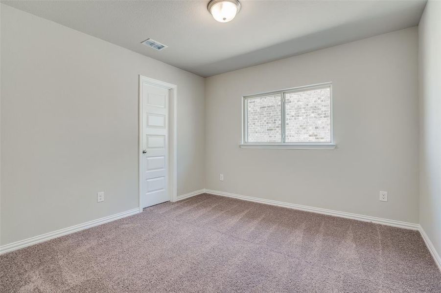 Spare room featuring baseboards and carpet floors Spare room featuring baseboards and carpet floors