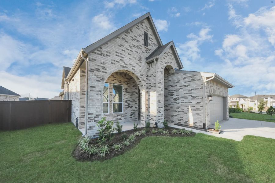 Representative exterior photo of a completed home built from the Bonneville by Chesmar Homes in Meridiana 50's and 60's, Manvel, TX (Image 27).