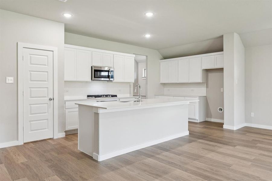 Kitchen in the Heisman home plan by Trophy Signature Homes – REPRESENTATIVE PHOTO