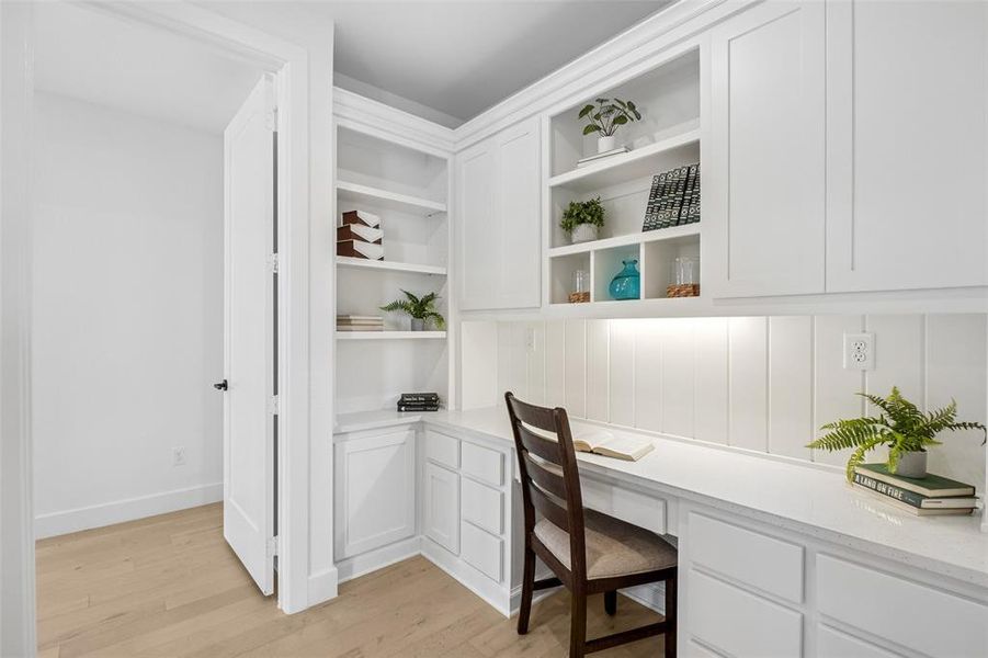 Office with built in study area and light wood-type flooring Office with built in study area and light wood-type flooring