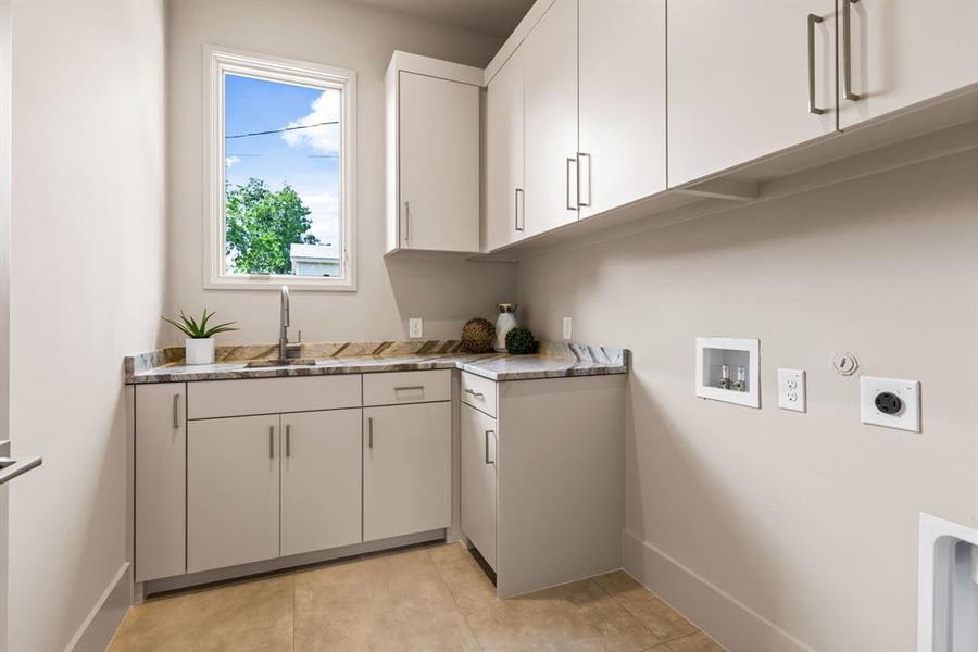 Laundry area featuring hookup for an electric dryer, hookup for a gas dryer, cabinet space, light tile patterned floors, and washer hookup Laundry area featuring hookup for an electric dryer, hookup for a gas dryer, cabinet space, light tile patterned floors, and washer hookup