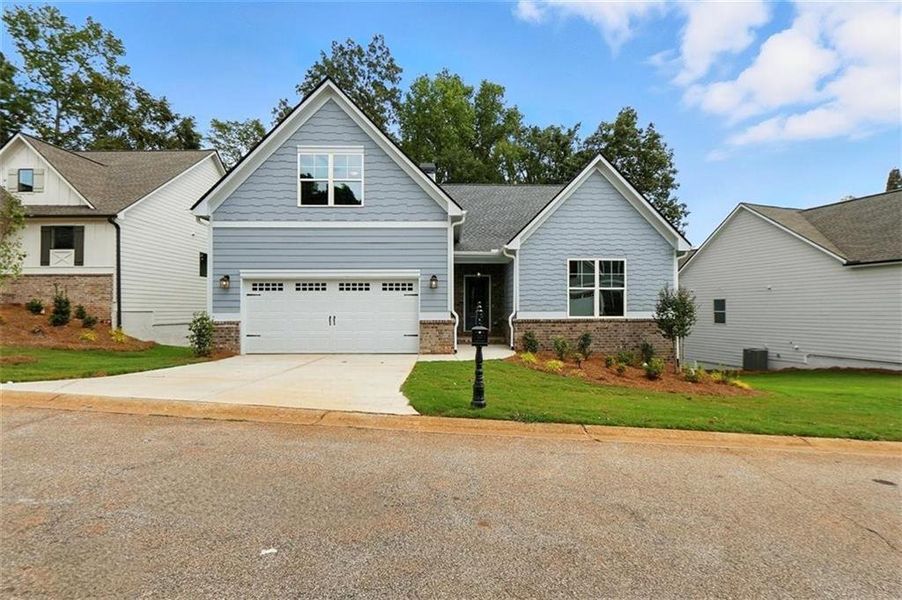 Front exterior of a new home in Traditions of Braselton, Jefferson, GA, highlighting curb appeal (Image 2). Front exterior of a new home in Traditions of Braselton, Jefferson, GA, highlighting curb appeal (Image 2).
