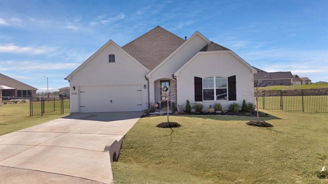 View of front of home with concrete driveway, brick siding, and roof with shingles View of front of home with concrete driveway, brick siding, and roof with shingles