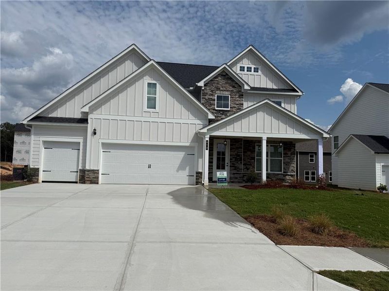 Front exterior of a new home in The Fairways at Mirror Lake, Villa Rica, GA, highlighting curb appeal (Image 1).