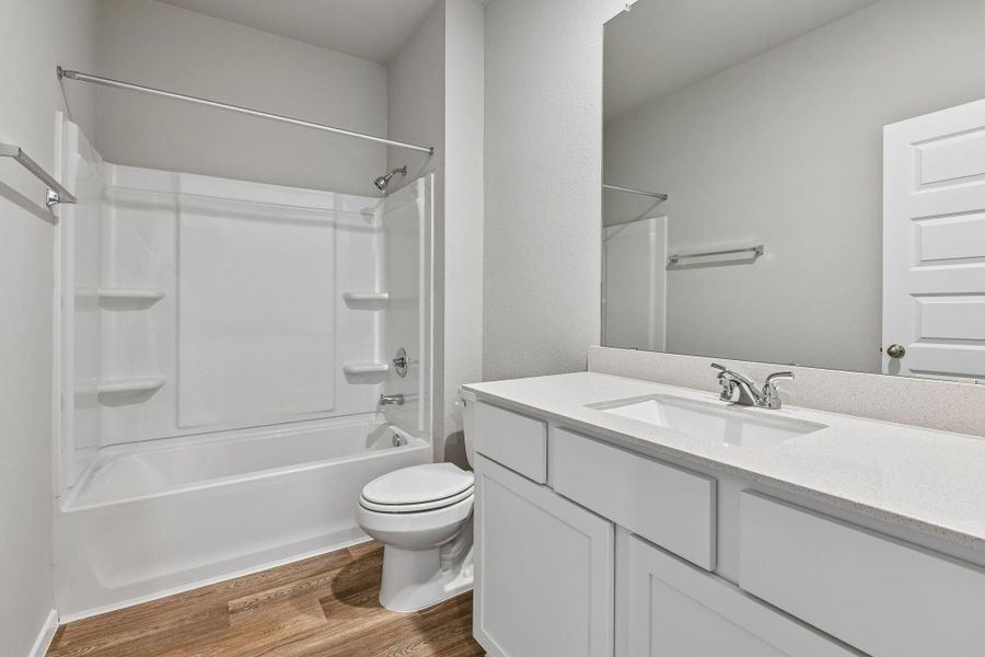 Featuring a combination tub and shower, ample counter space, and bright lighting, this space is perfect for kids, guests, or busy mornings.