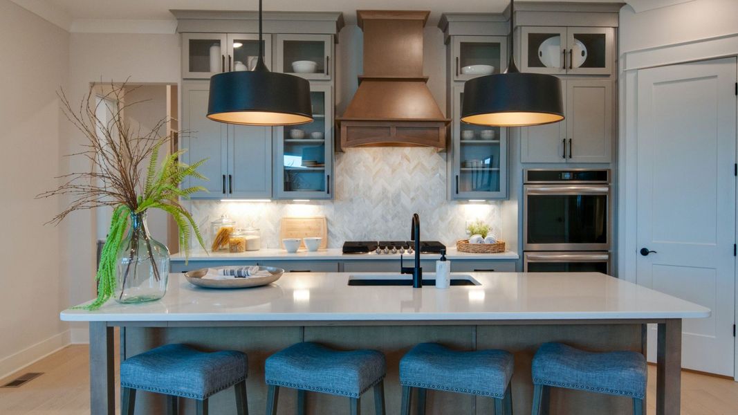 Kitchen with upgraded appliances and modern floor-to-ceiling cabinets Kitchen with upgraded appliances and modern floor-to-ceiling cabinets