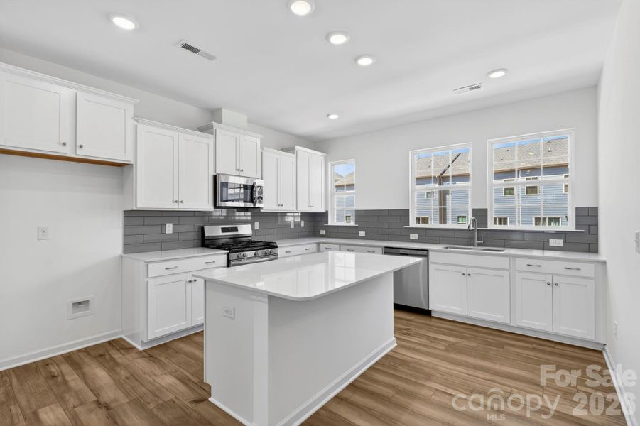 Just look at that gorgeous grey subway tile backsplash !