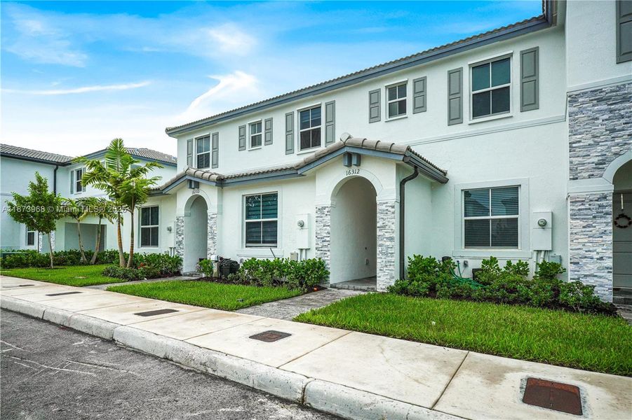 Front exterior of a new home in , Homestead, FL, highlighting curb appeal (Image 19).