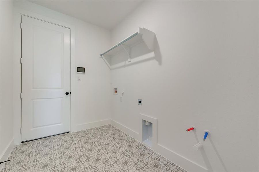 Washroom with hookup for an electric dryer, washer hookup, and hookup for a gas dryer