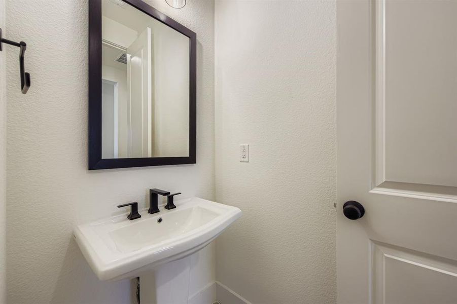 Bathroom with a textured wall and a sink Bathroom with a textured wall and a sink