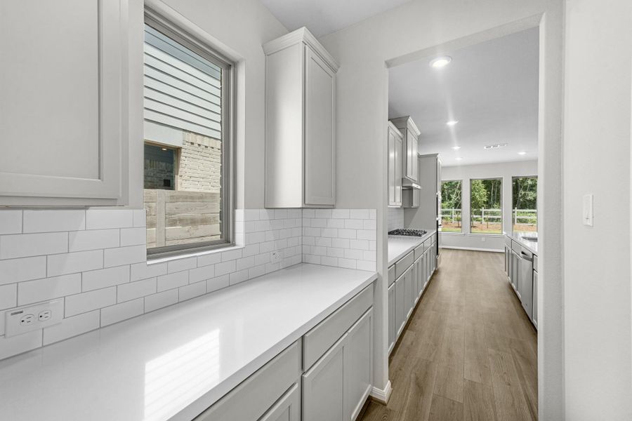Butler's pantry leading you from the formal dining room to the kitchen.
