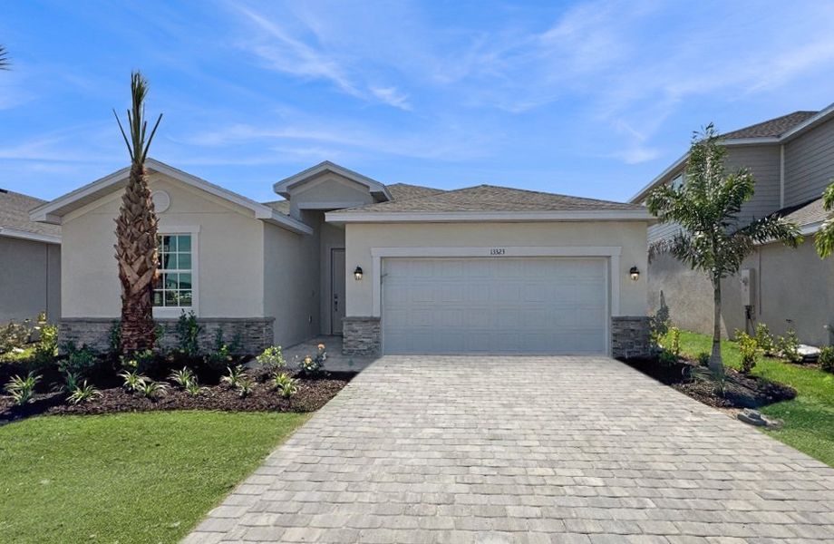 Front exterior of a new home in Lennar at Turnleaf: Executive Homes, Punta Gorda, FL, highlighting curb appeal (Image 1).