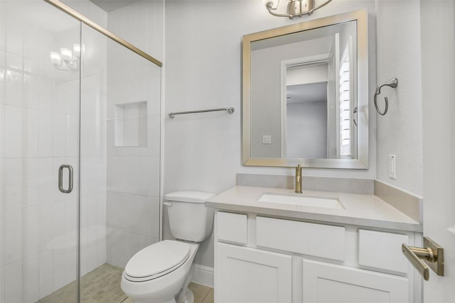 Private bath for bedroom three has glass enclosed shower. Private bath for bedroom three has glass enclosed shower.