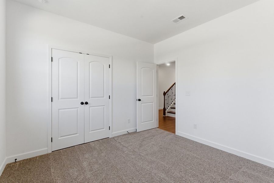 A hallway with white doors.