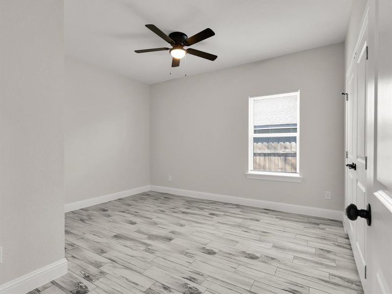 Spare room featuring ceiling fan and light wood-type flooring