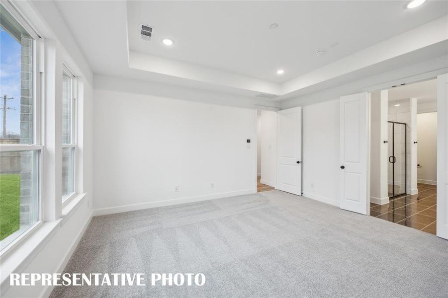 Located at the rear of the home for additional privacy, this peaceful owner's suite is the perfect place to relax and renew.  REPRESENTATIVE PHOTO