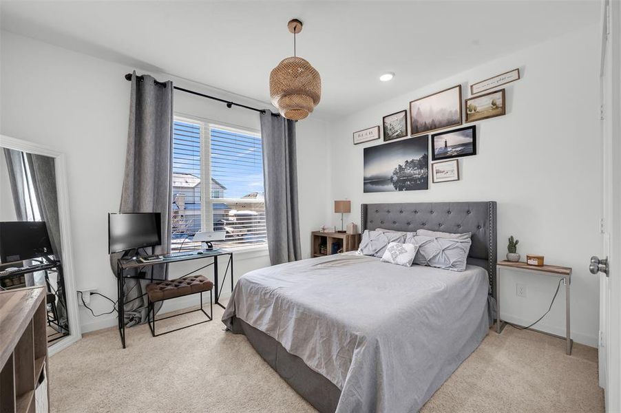 Bedroom featuring light colored carpet