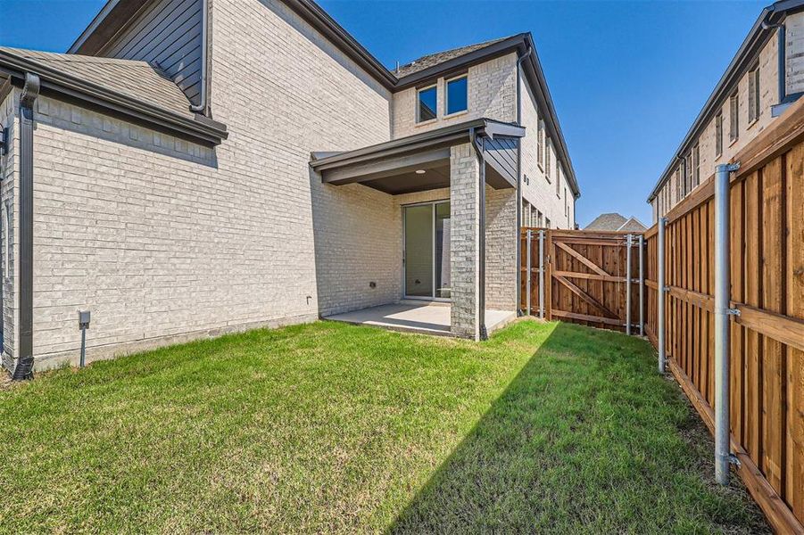 Rear view of property with a patio and a yard