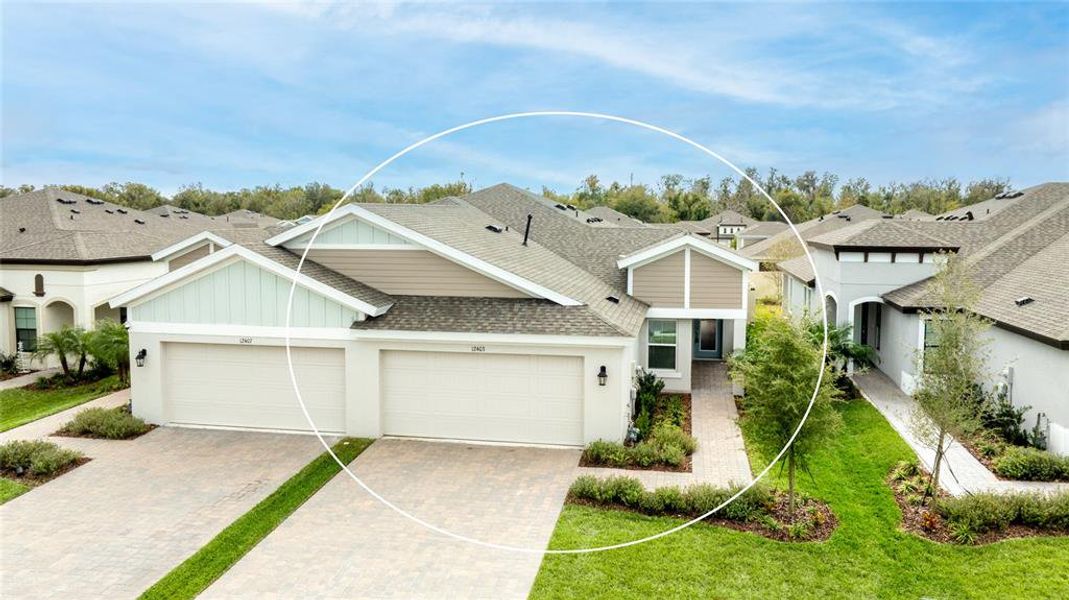 Front exterior of a new home in Crosswind Point, Parrish, FL, highlighting curb appeal (Image 22).