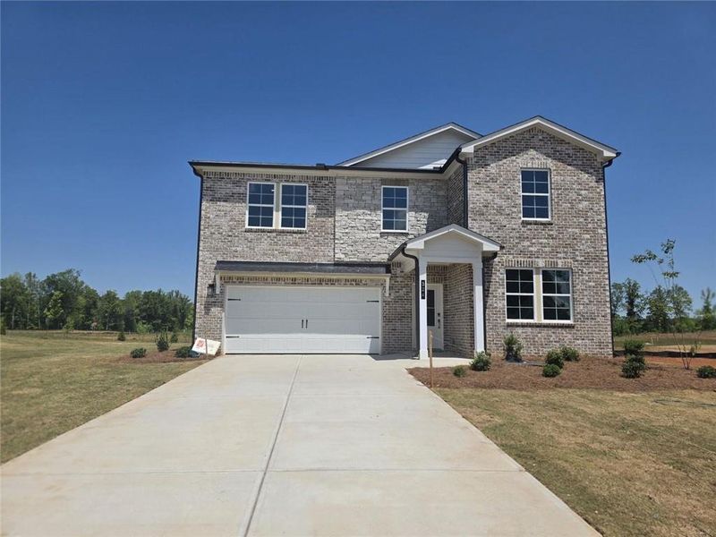 Front exterior of a new home in Walker Grove, McDonough, GA, highlighting curb appeal (Image 1). Front exterior of a new home in Walker Grove, McDonough, GA, highlighting curb appeal (Image 1).