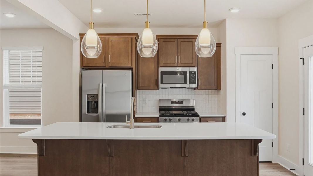 Elegant and compact island anchors this tasteful kitchen with high standards and timeless appeal at Marion Square Elegant and compact island anchors this tasteful kitchen with high standards and timeless appeal at Marion Square