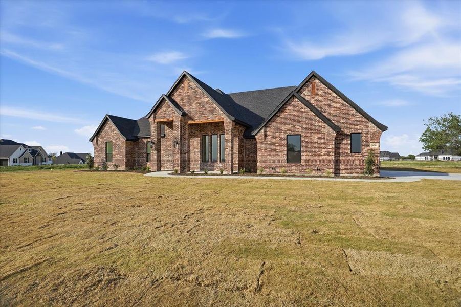 Front exterior of a new home in , Springtown, TX, highlighting curb appeal (Image 22).