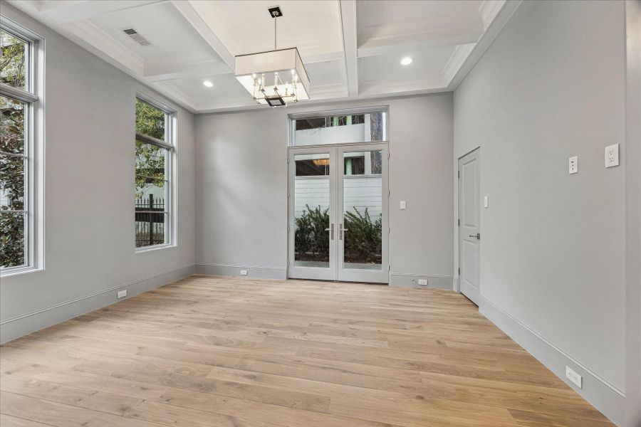 Off the entry is the dedicated office or formal dining with coffered ceiling. Designer light fixture, spaciouscloset, and pocket doors complete this spacious room.