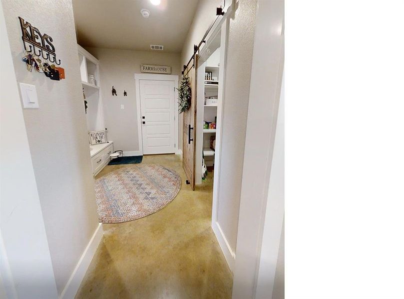 Muddrom/Hallway featuring a Pantry entrance, bench and rack Muddrom/Hallway featuring a Pantry entrance, bench and rack