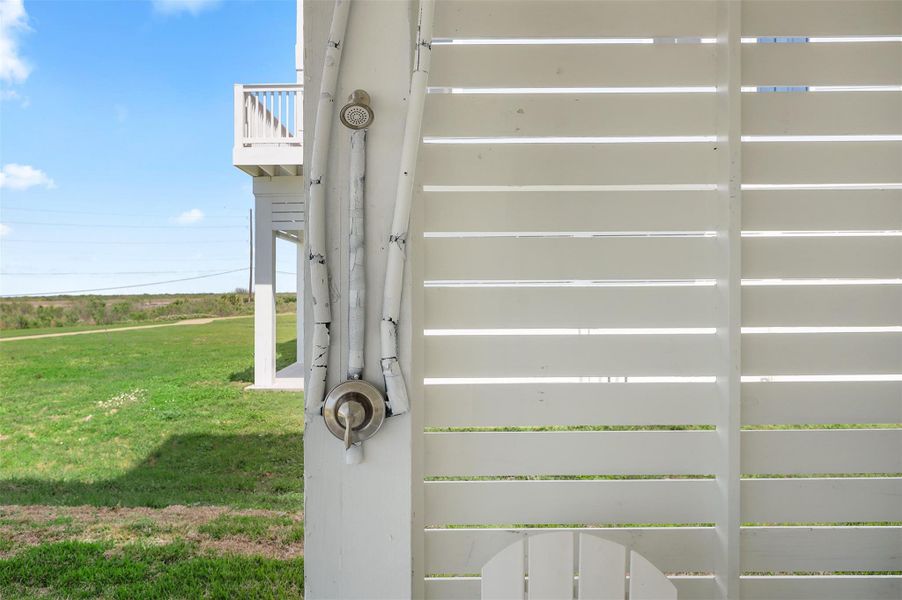 The outdoor shower is a must-have for beachside living, making it easy to rinse off sand before heading inside.