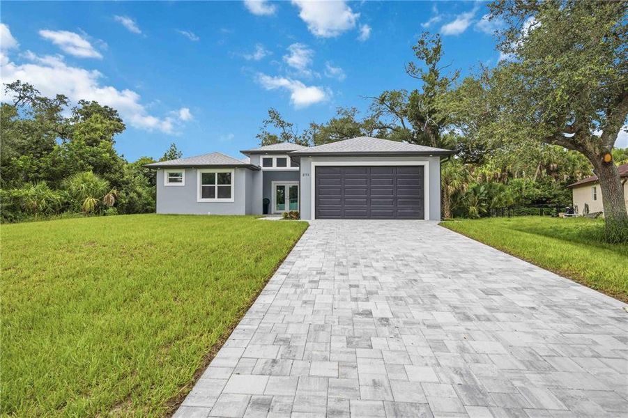 Front exterior of a new home in , North Port, FL, highlighting curb appeal (Image 26). Front exterior of a new home in , North Port, FL, highlighting curb appeal (Image 26).