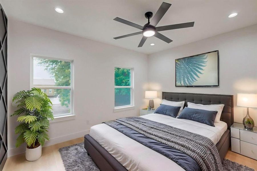Bedroom featuring light wood-type flooring, recessed lighting, and a ceiling fan Bedroom featuring light wood-type flooring, recessed lighting, and a ceiling fan