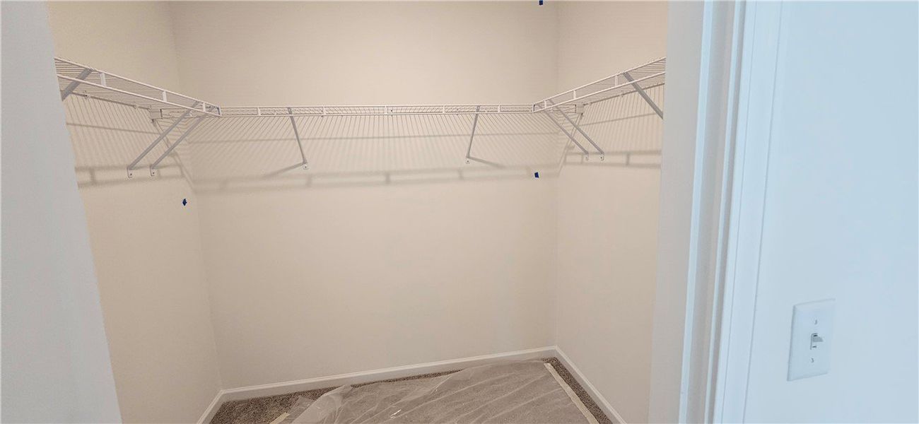 This spacious closet offers ample storage and orga This spacious closet offers ample storage and orga