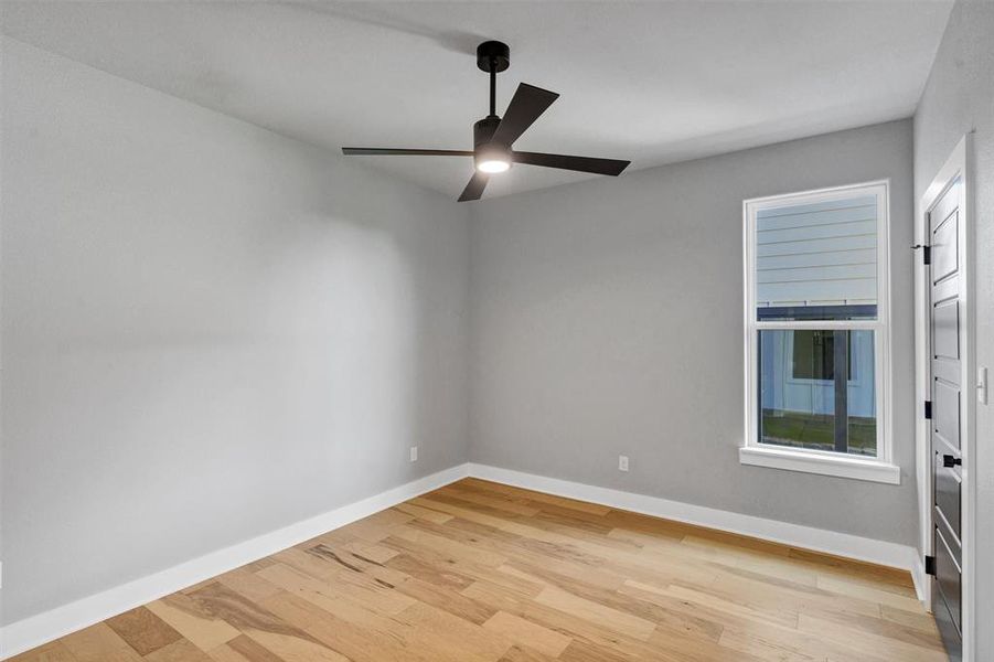 Unfurnished room with light wood-style floors and ceiling fan