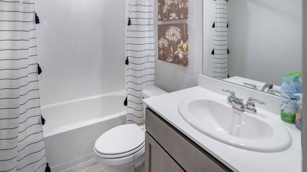 Bathroom with shower / bath combo with shower curtain and vanity Bathroom with shower / bath combo with shower curtain and vanity