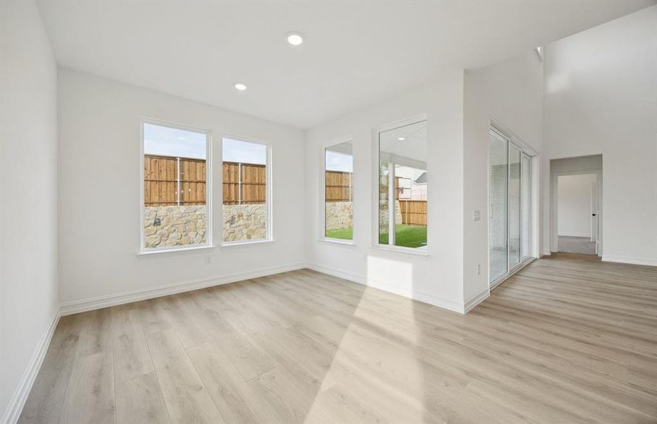 Dining nook off kitchen with large windows