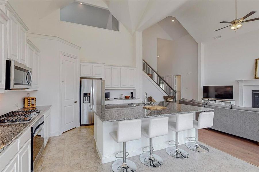 Kitchen featuring stainless steel appliances, gas stove, and breakfast bar.